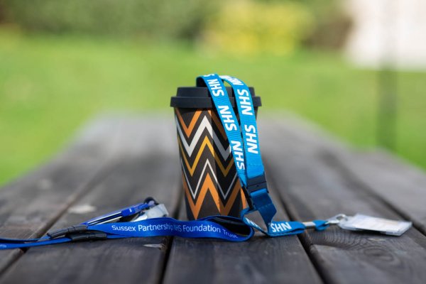 Coffee cup with NHS lanyard
